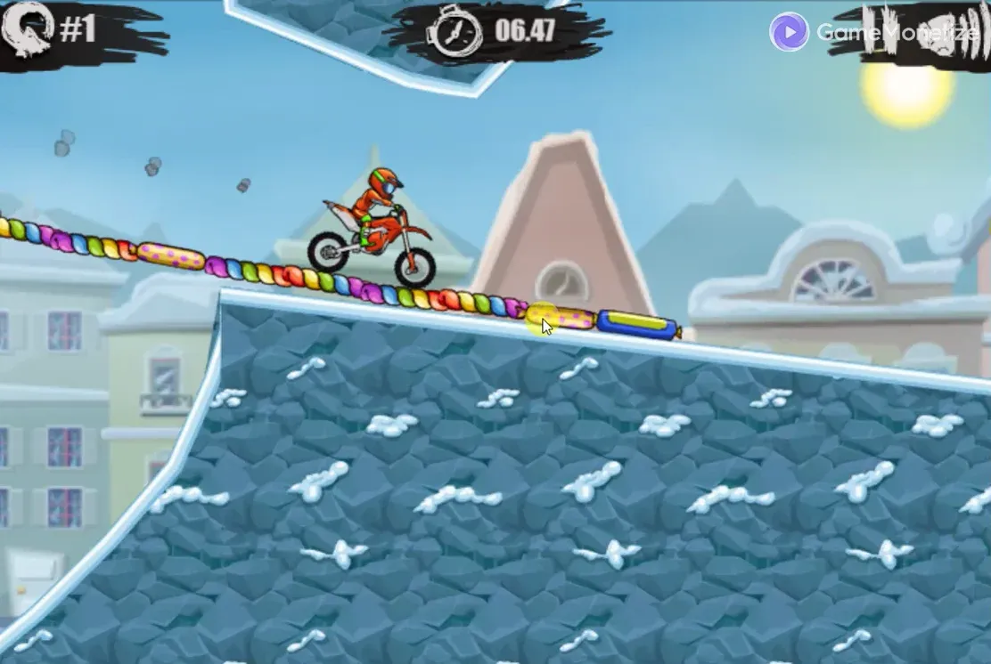 Moto X3M Winter bike riding across a candy-colored track above a snowy stone ramp